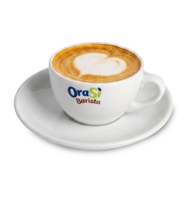 Bijela šalica za cappuccino s latte art motivom srca, natpis "OraSì Barista", na tanjuriću, bijela pozadina