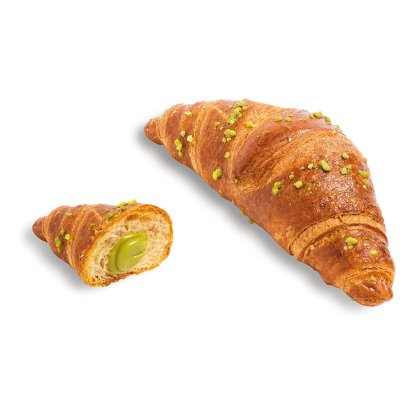 Zlatni croissant posut sitno mljevenim pistacijama, polovica s kremastim zelenim pistacija nadjevom.